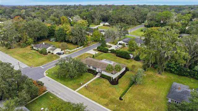 an aerial view of a house with a yard