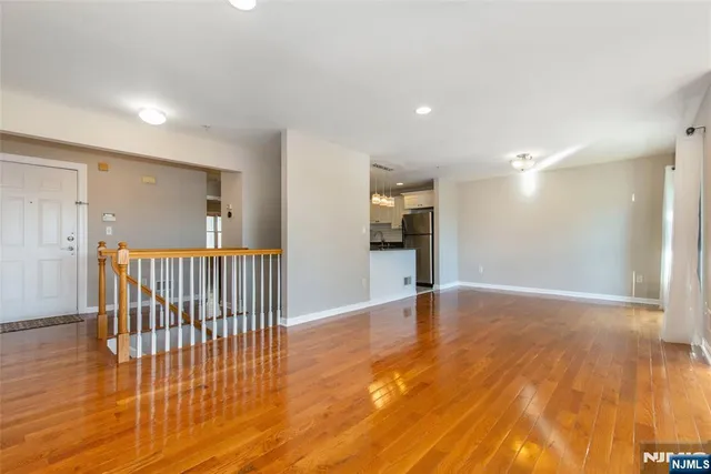 a kitchen with a refrigerator and a stove top oven