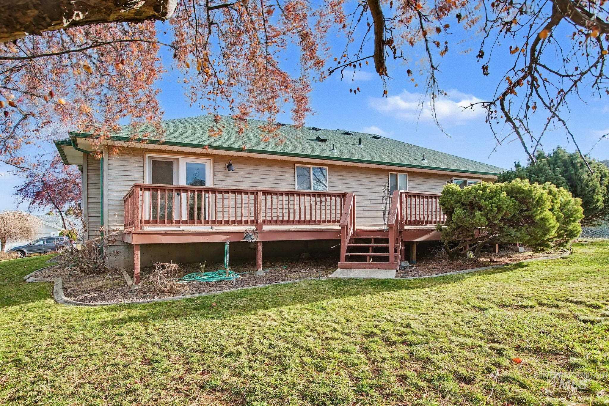 2242 Chukar Lane Clarkston, WA 99403 - Photo 2 of 41 Rear view of house with a deck, a yard, and roof with shingles