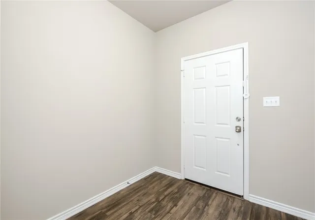an empty room with wooden floor