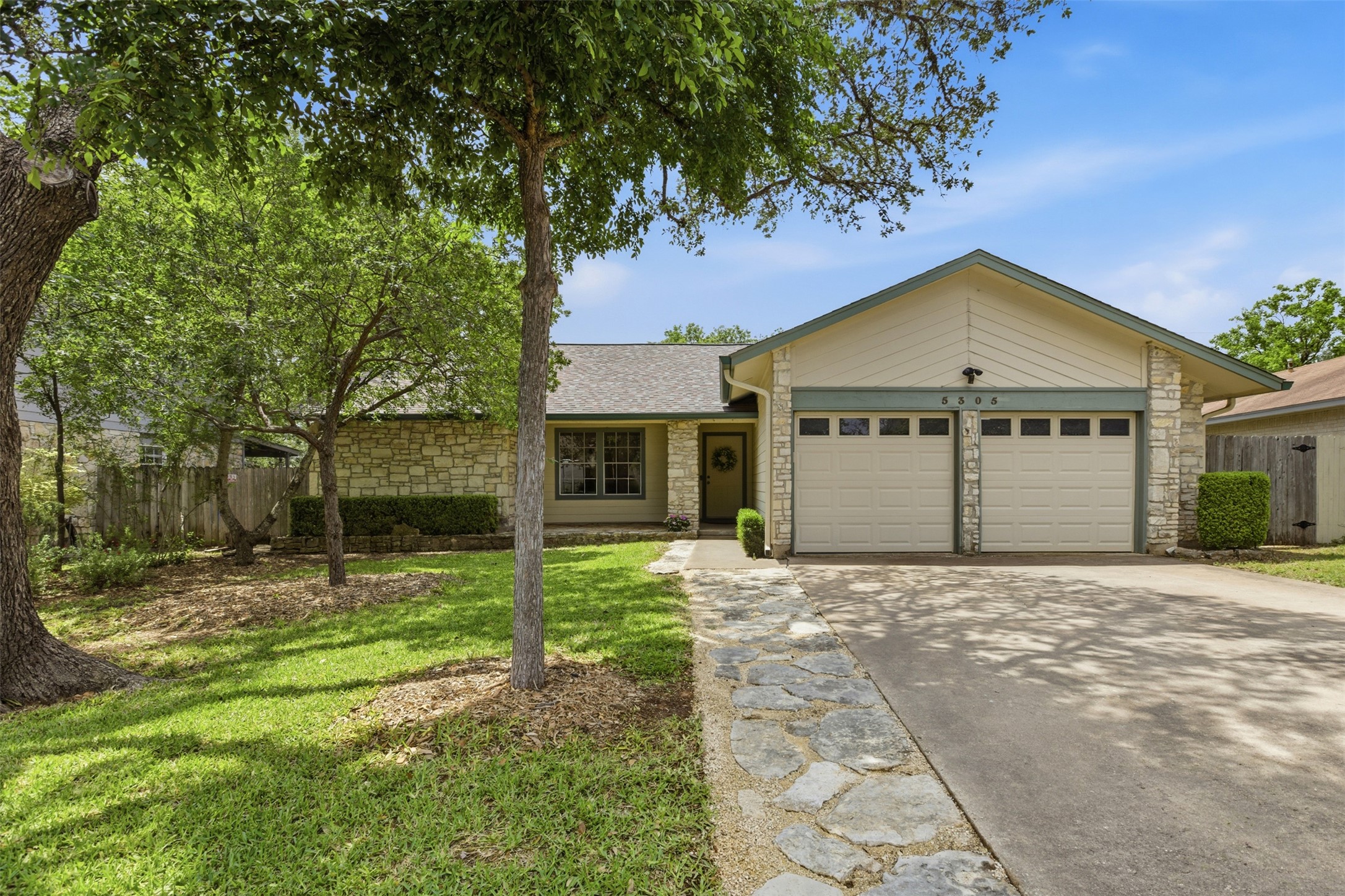 5305 Wolf Run Austin, TX 78749 - Photo 15 of 37 Single-story residence featuring a stone and stucco facade, a two-car garage, and a flagstone pathway