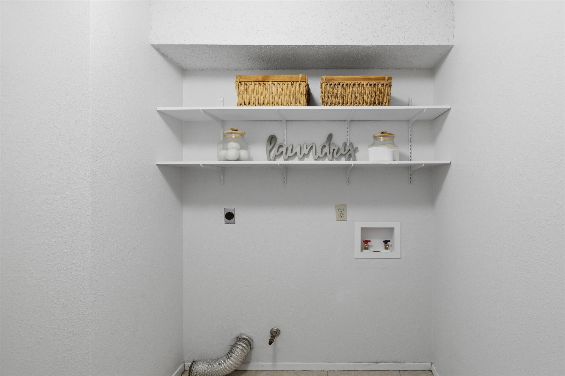 5305 Wolf Run Austin, TX 78749 - Photo 27 of 37 Dedicated utility space featuring open shelving, appliance hookups, and a tiled floor