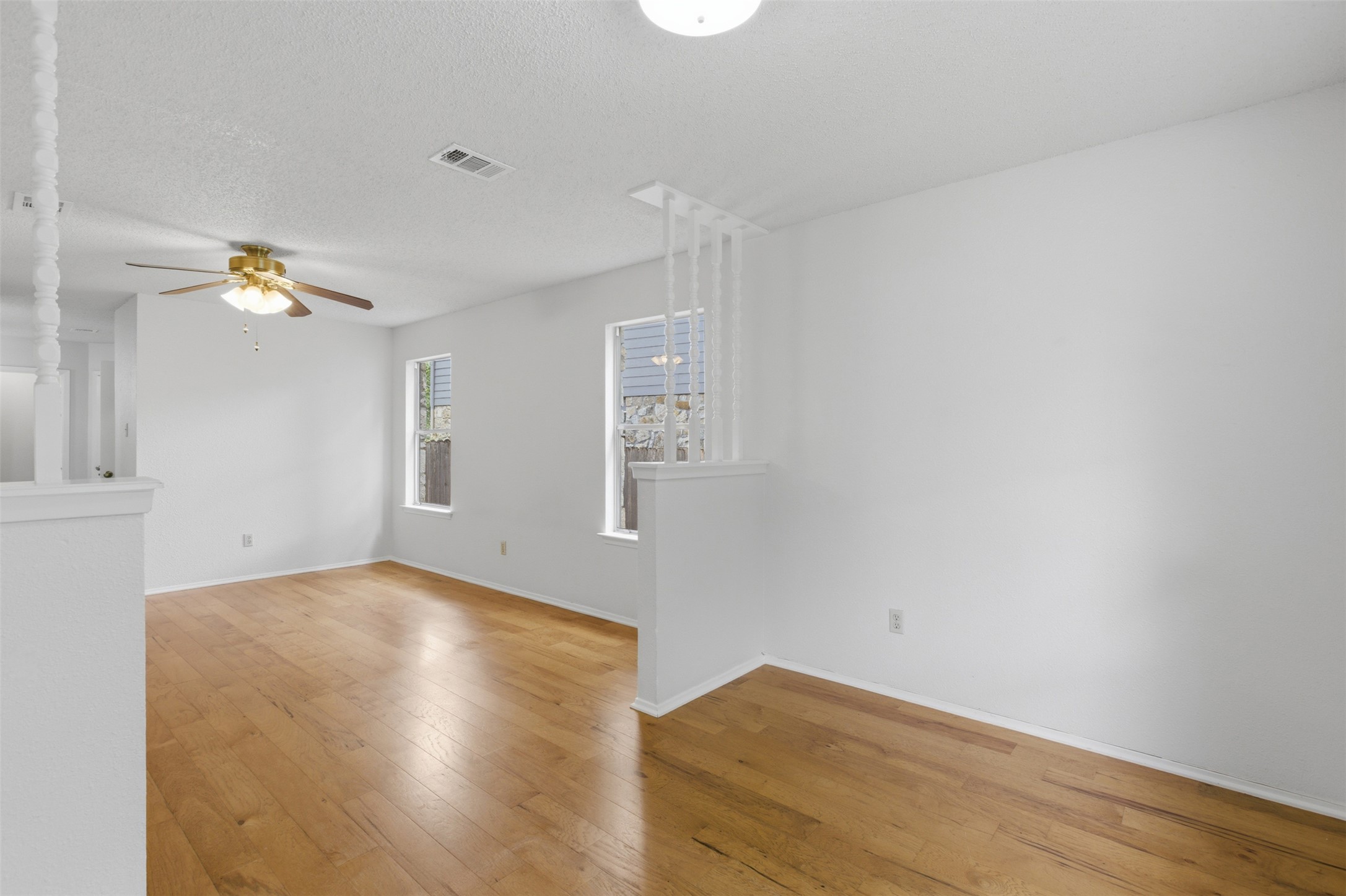 5305 Wolf Run Austin, TX 78749 - Photo 32 of 37 Bright interior space featuring wood-finish flooring, white painted walls, and white trim