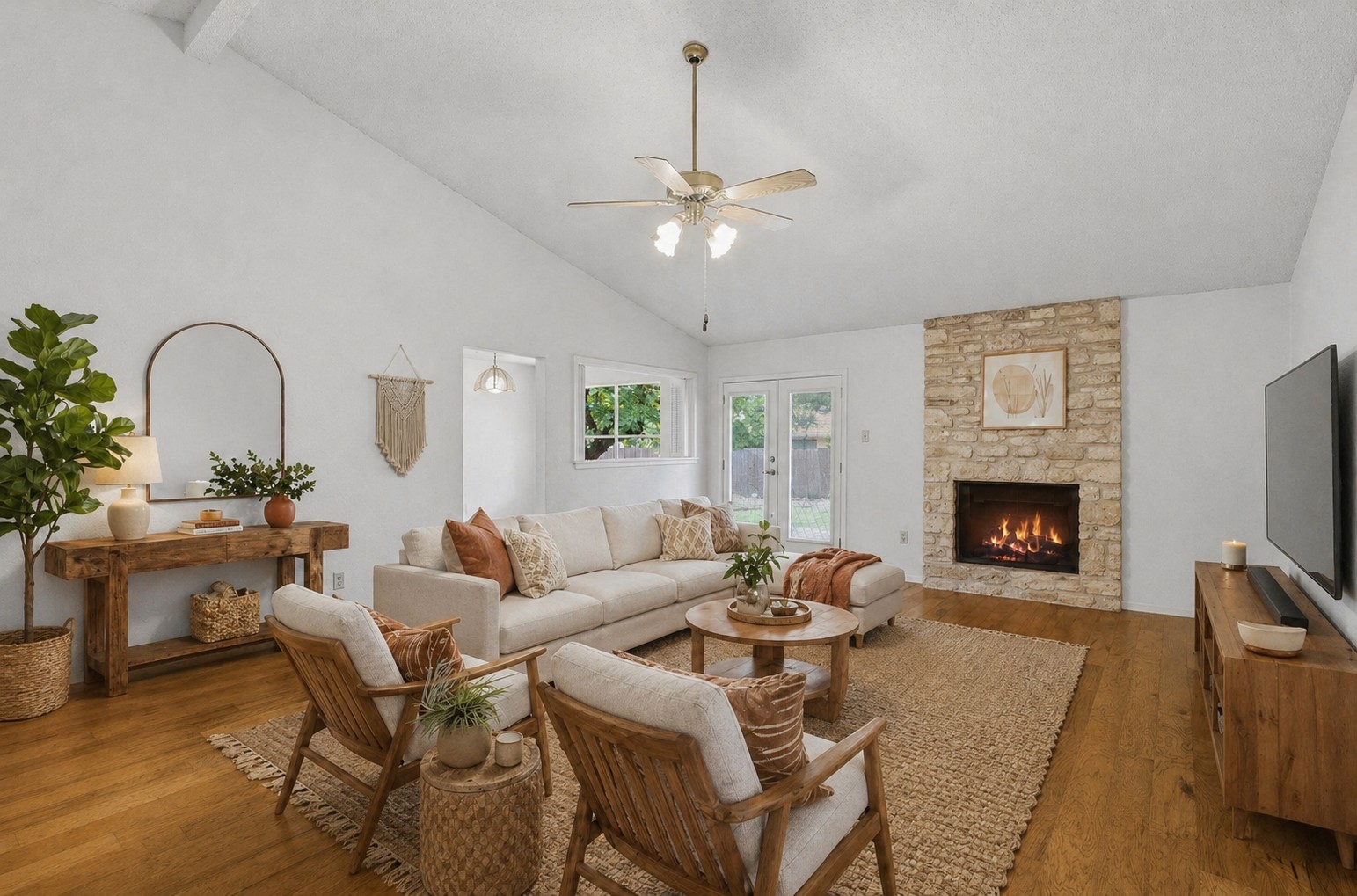 5305 Wolf Run Austin, TX 78749 - Photo 4 of 37 Living area featuring vaulted ceilings, a stone-clad fireplace, wood-finish flooring, and French doors