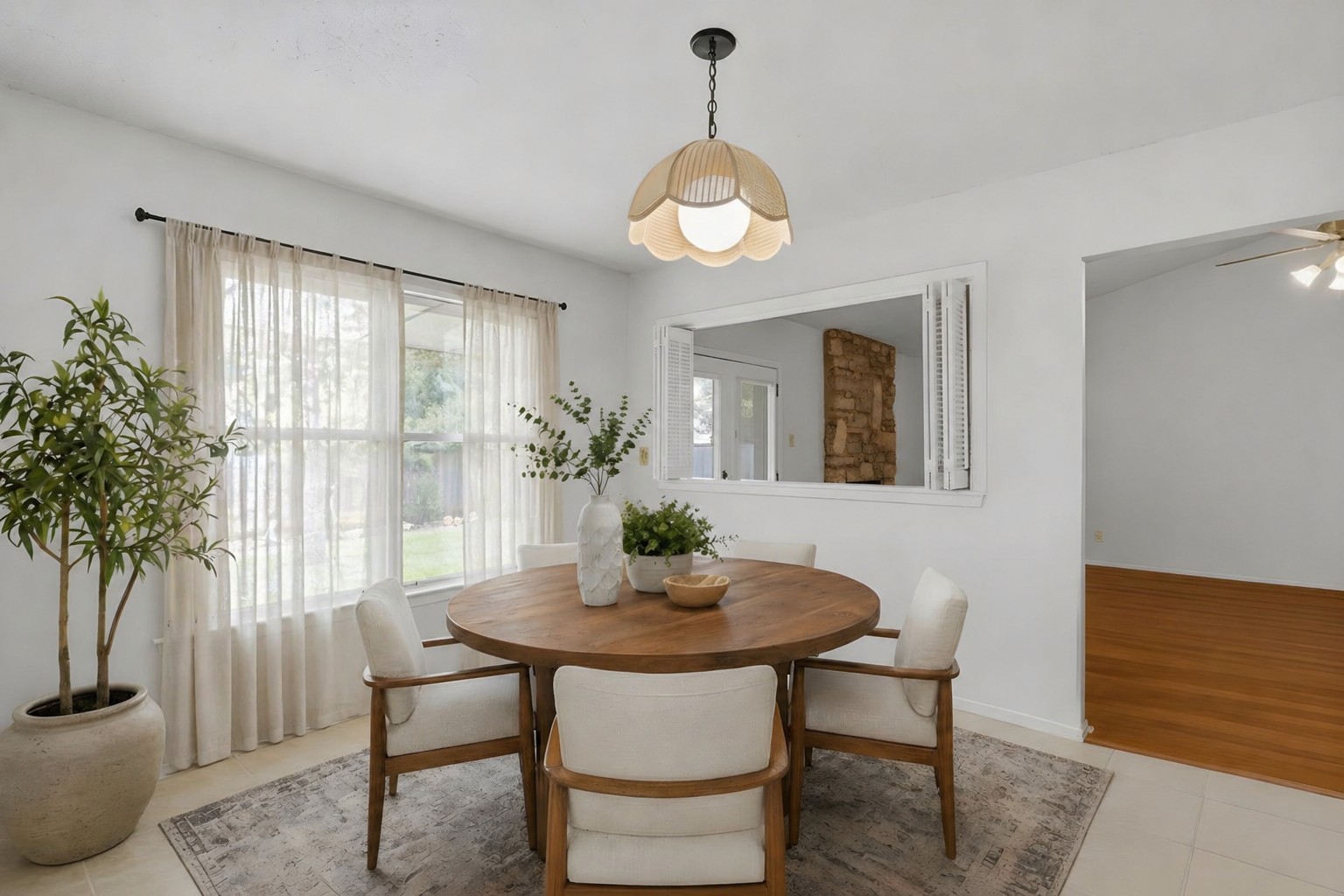 5305 Wolf Run Austin, TX 78749 - Photo 5 of 37 Bright dining area featuring a wood-finish round table, four upholstered chairs, and a decorative pendant light fixture