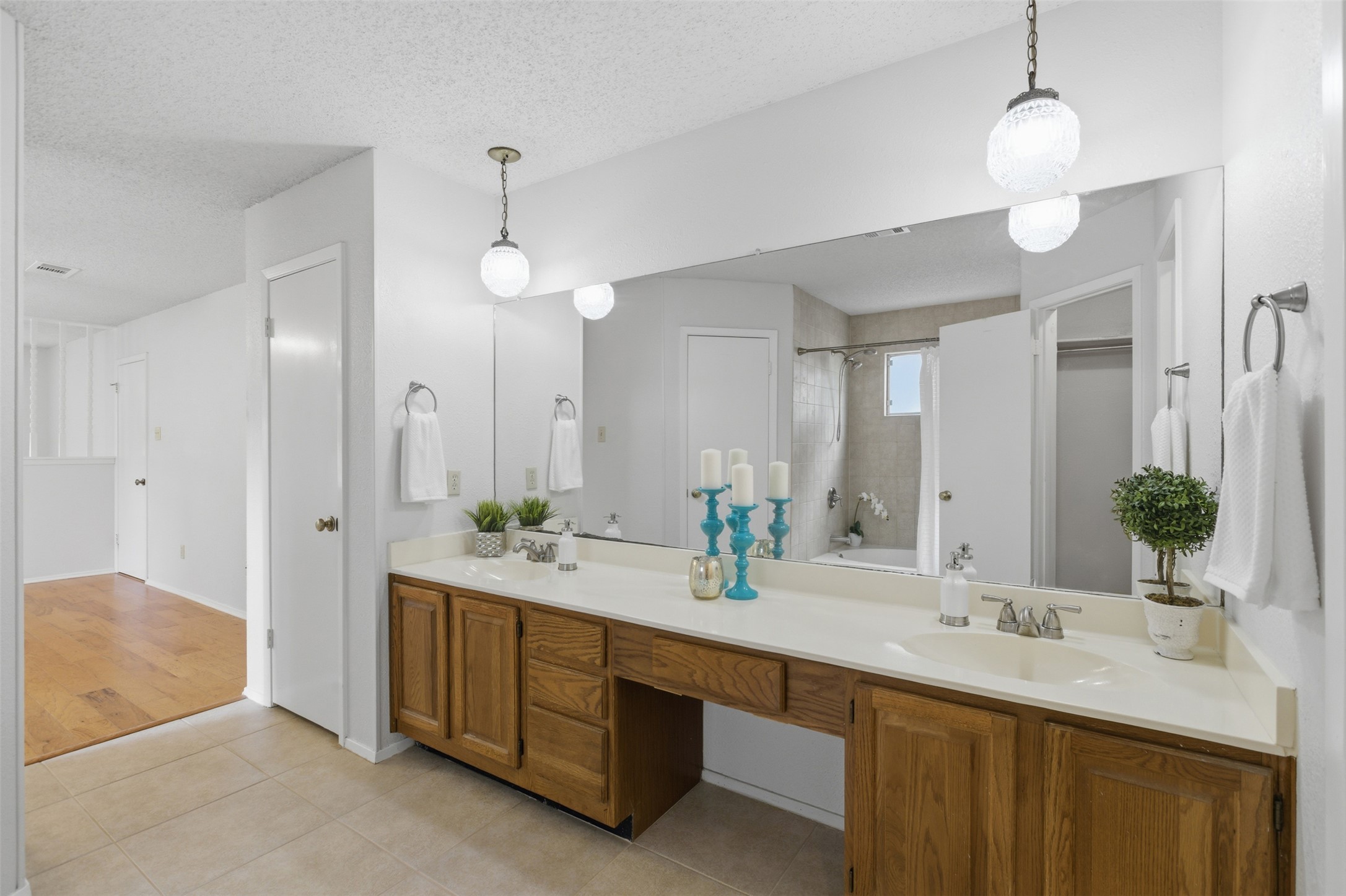 5305 Wolf Run Austin, TX 78749 - Photo 8 of 37 Bathroom vanity featuring dual sinks, a spacious countertop, wood-finish cabinetry, and a full-width wall mirror