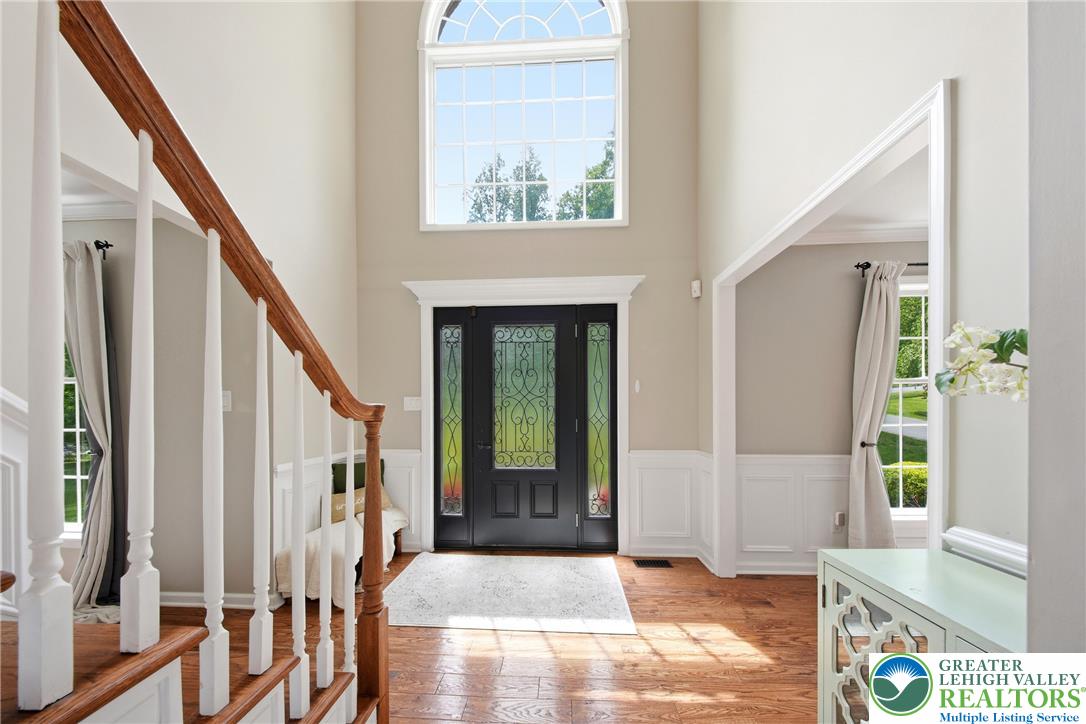 115 West Butternut Road Hellertown, PA 18055 - Photo 12 of 97 A grand entrance welcomes with soaring ceilings, a leaded glass door, and rich hardwood floors.
