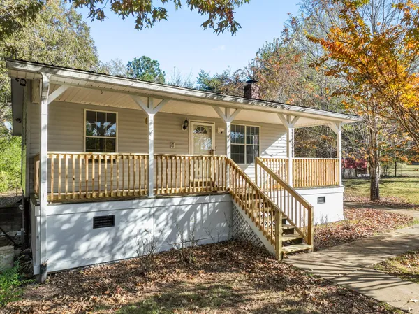 an outdoor view of a house with a yard