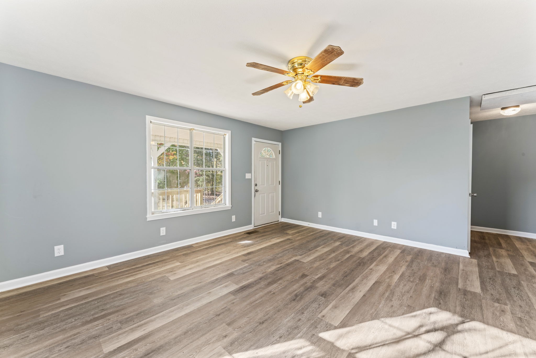 7736 Dice Lampley Road Fairview, TN 37062 - Photo 12 of 27 a view of an empty room with wooden floor and a window