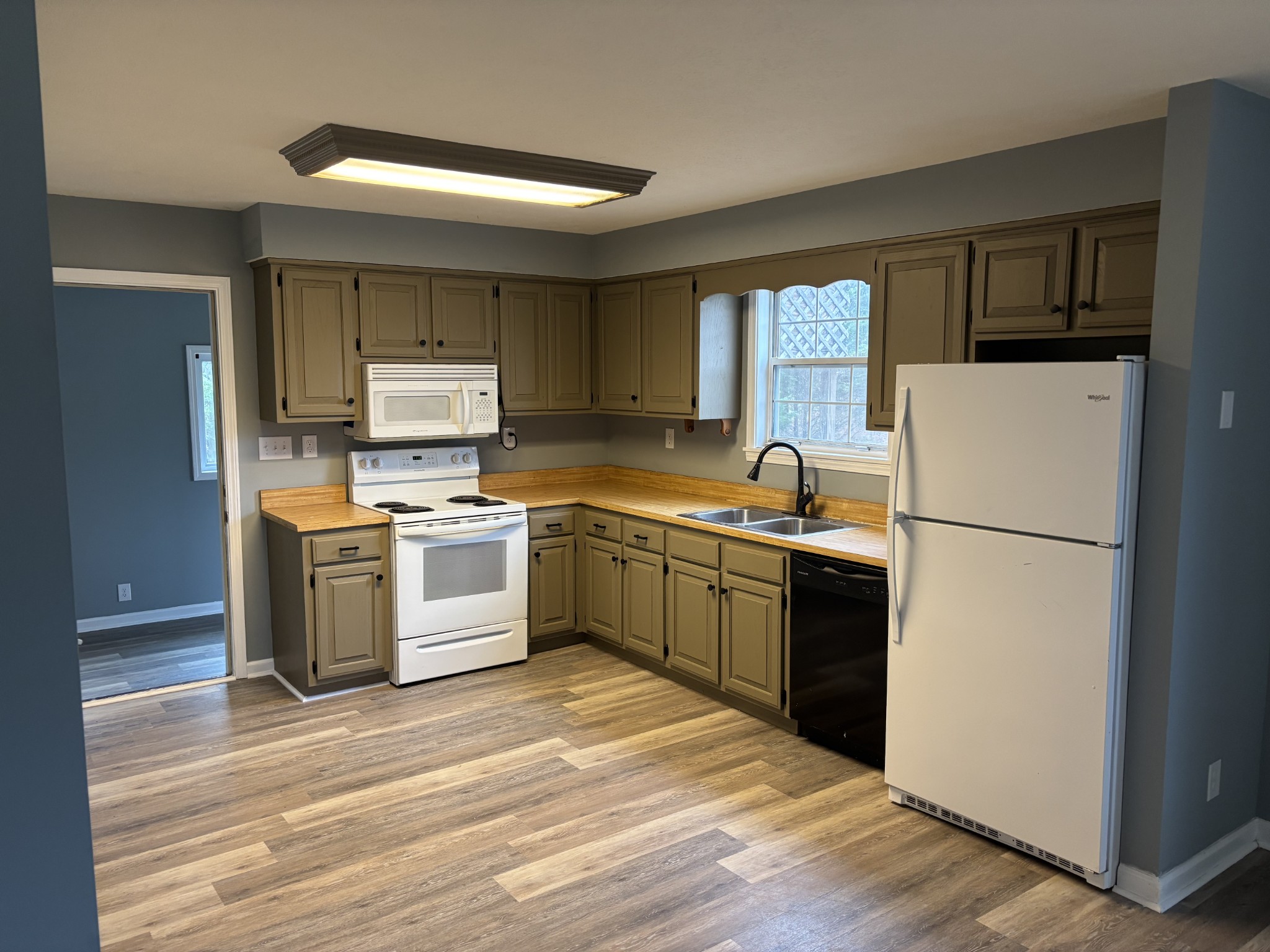 7736 Dice Lampley Road Fairview, TN 37062 - Photo 13 of 27 a kitchen with a sink a refrigerator and cabinets