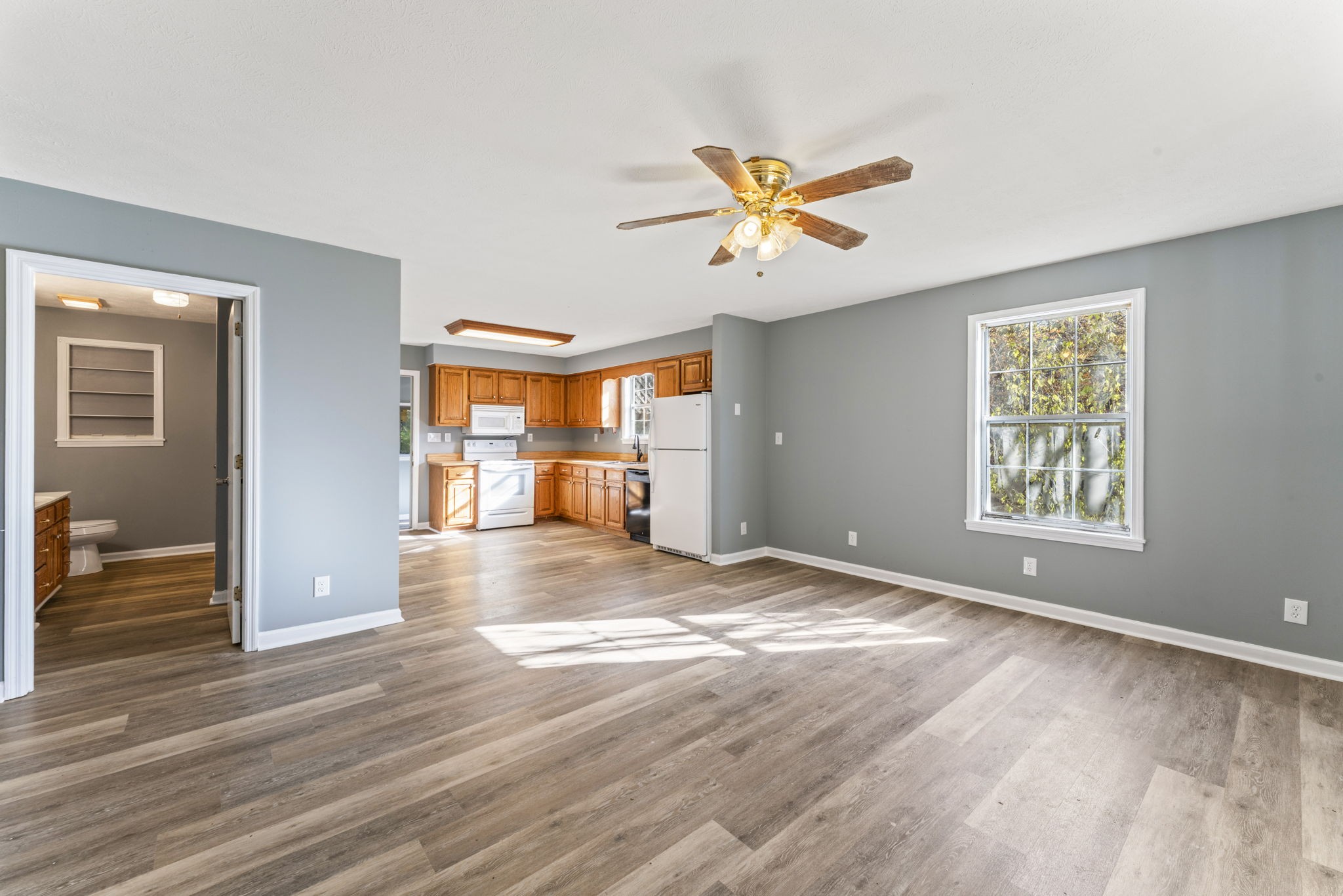 7736 Dice Lampley Road Fairview, TN 37062 - Photo 9 of 27 a view of empty room with wooden floor and fan