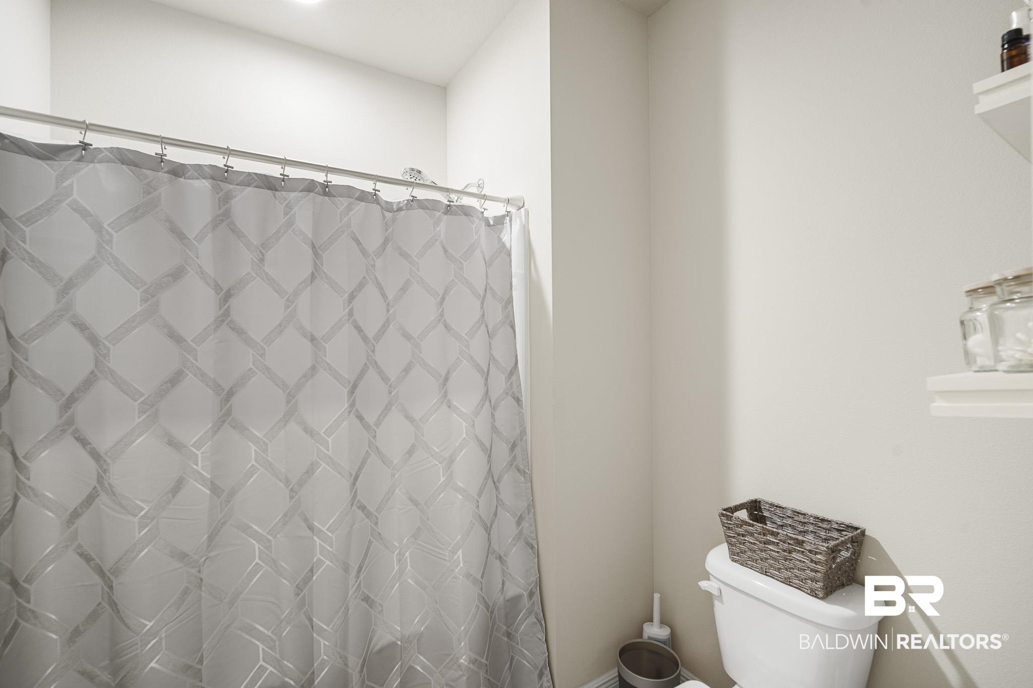 24765 Spectacular Bid Loop Daphne, AL 36526 - Photo 39 of 45 Bathroom with toilet and curtained shower