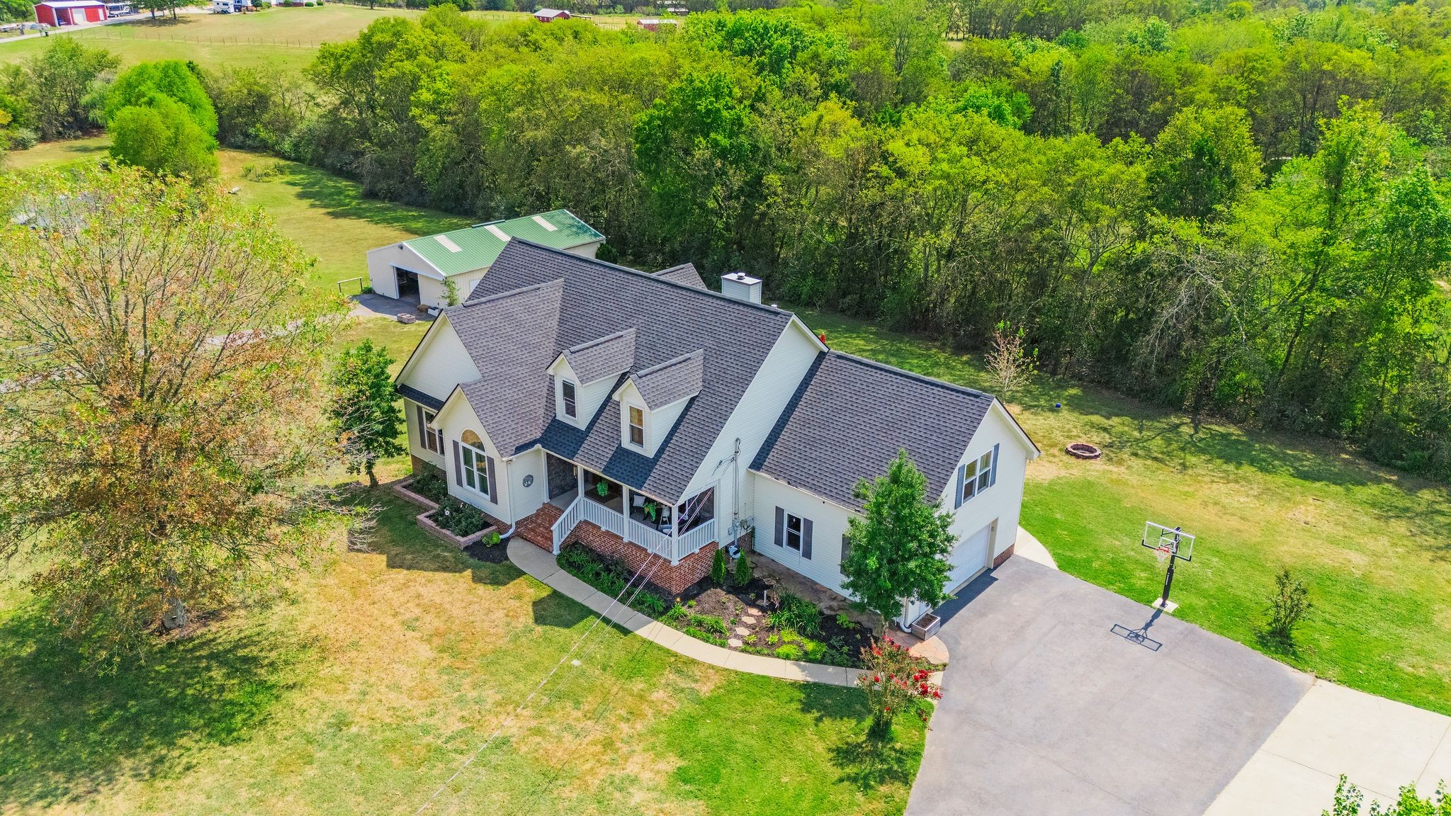 an aerial view of a house with garden space and street view