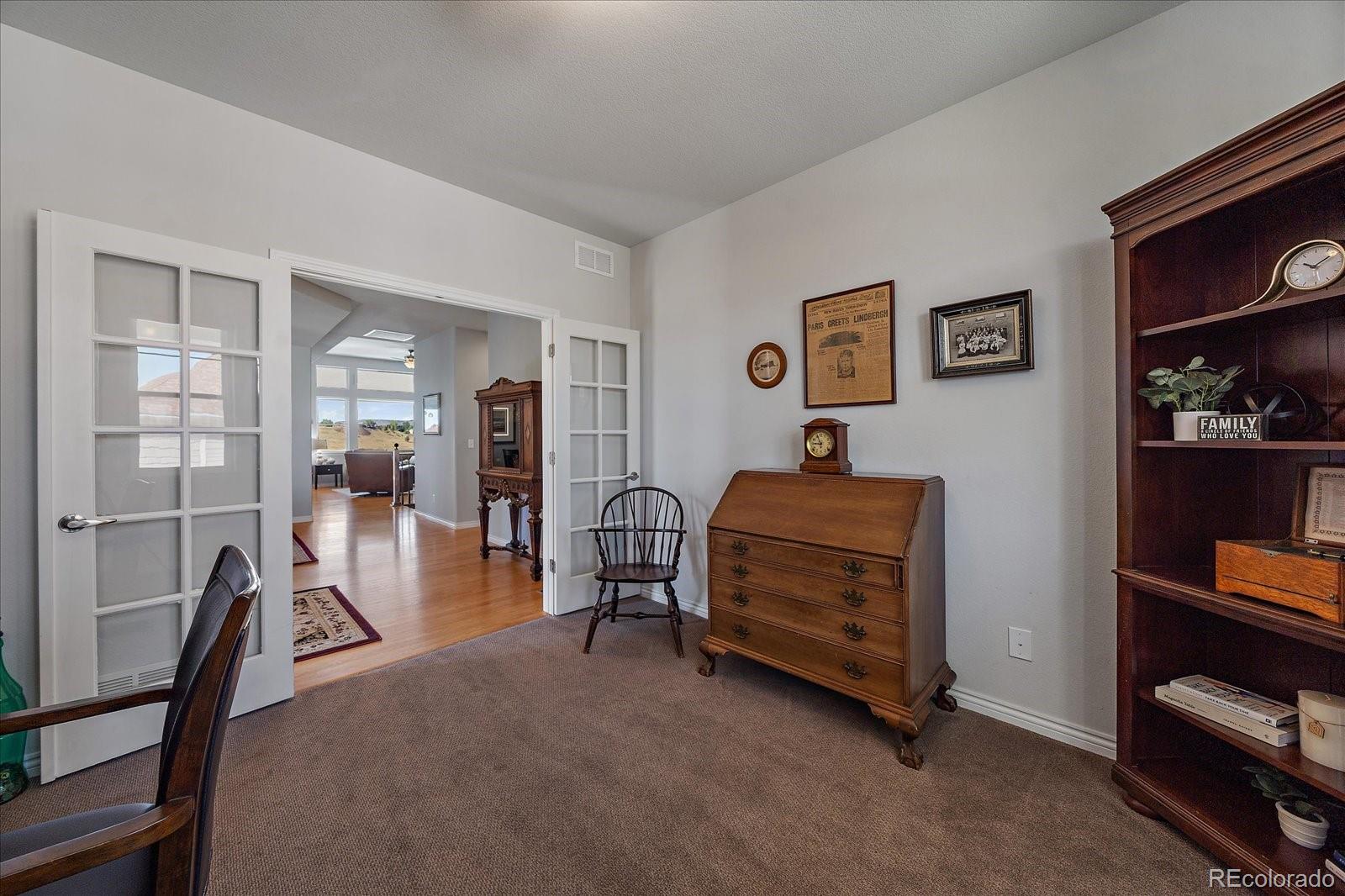 8412 Quaker Circle Arvada, CO 80007 - Photo 25 of 44 a view of a livingroom with furniture and a flat screen tv