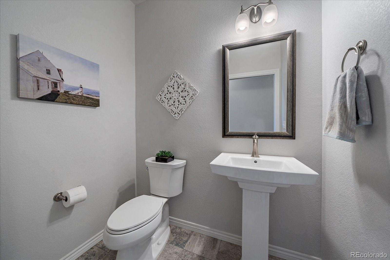 8412 Quaker Circle Arvada, CO 80007 - Photo 26 of 44 a bathroom with a toilet sink and mirror