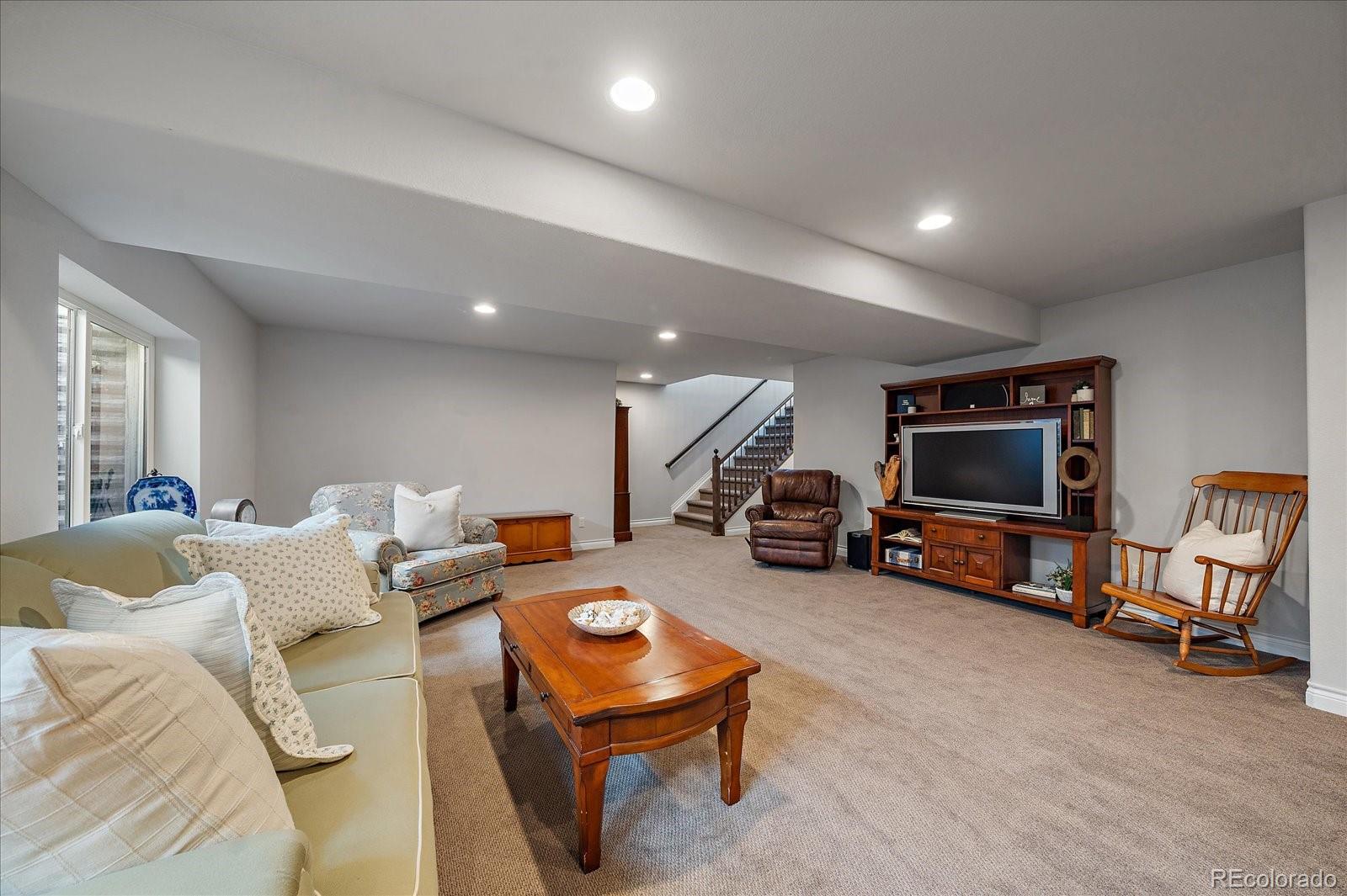 8412 Quaker Circle Arvada, CO 80007 - Photo 29 of 44 a living room with furniture and a flat screen tv