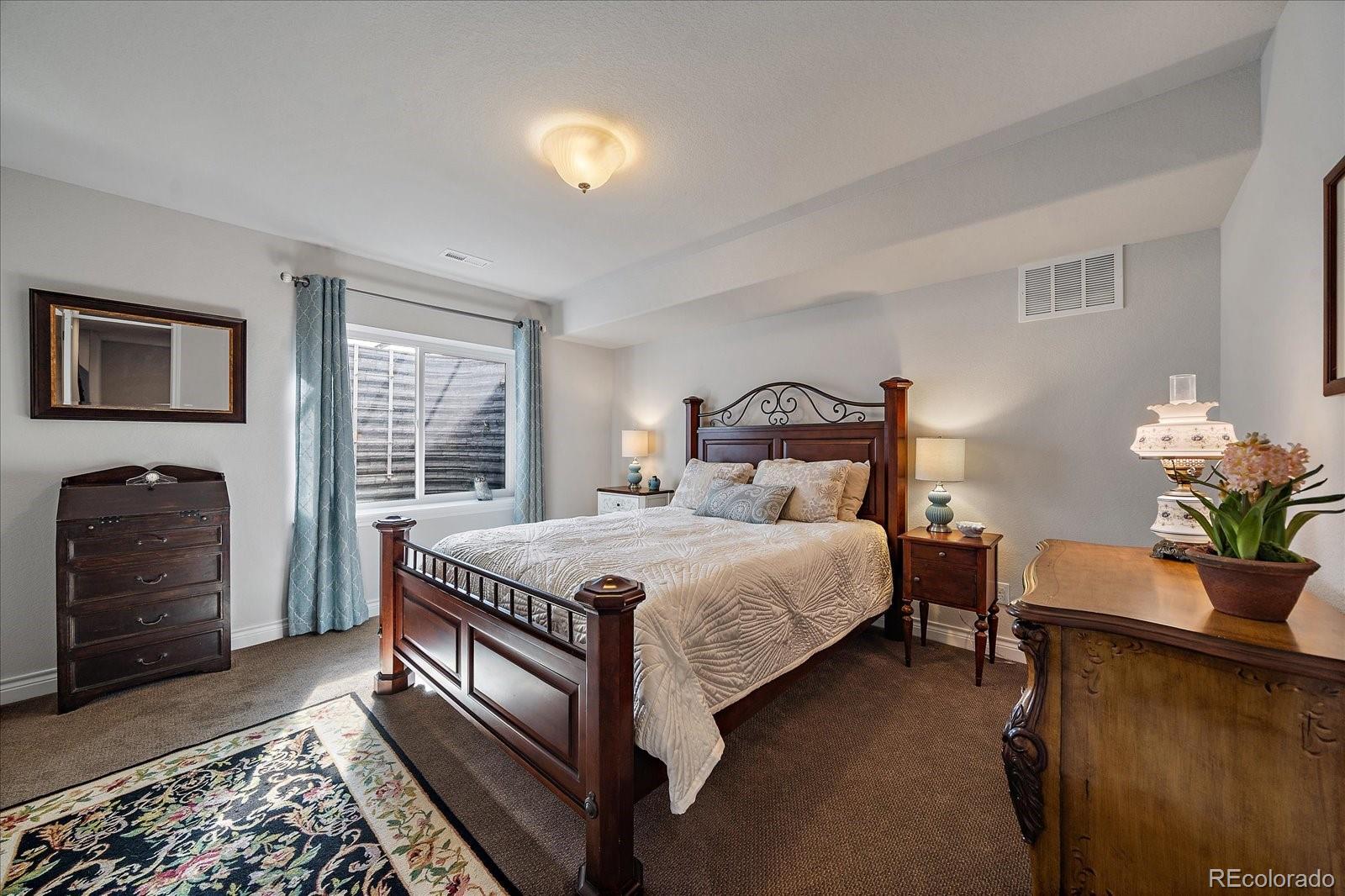 8412 Quaker Circle Arvada, CO 80007 - Photo 30 of 44 a bedroom with a bed and a potted plant