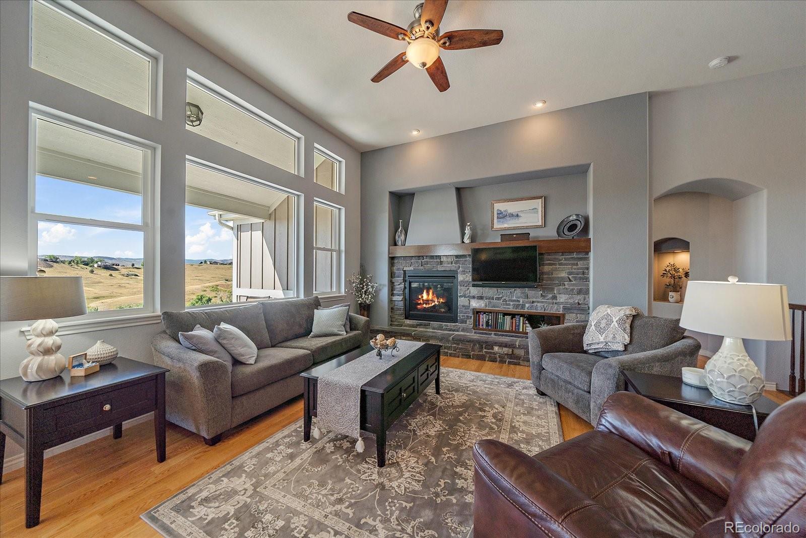 8412 Quaker Circle Arvada, CO 80007 - Photo 3 of 44 a living room with furniture or couch and a flat screen tv