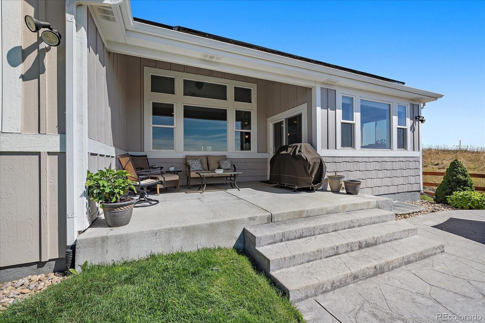 8412 Quaker Circle Arvada, CO 80007 - Photo 34 of 44 a front view of a house with potted plants