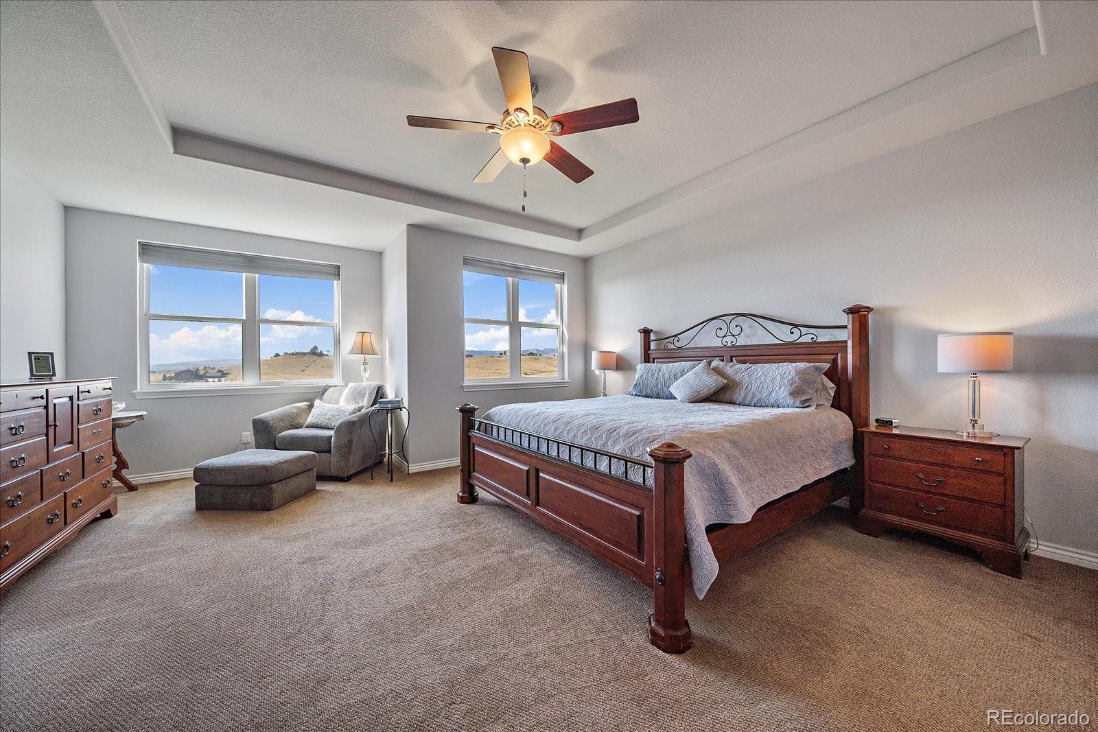 8412 Quaker Circle Arvada, CO 80007 - Photo 4 of 44 a bedroom with a bed and a chandelier