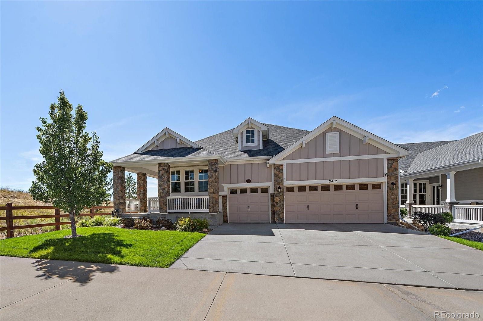 8412 Quaker Circle Arvada, CO 80007 - Photo 7 of 44 a front view of a house with a yard and garage