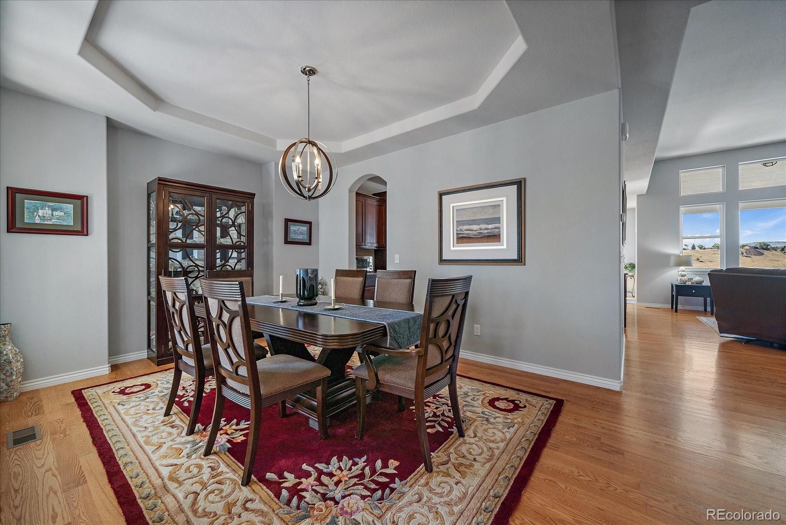 8412 Quaker Circle Arvada, CO 80007 - Photo 10 of 44 a view of a dining room with furniture window and wooden floor