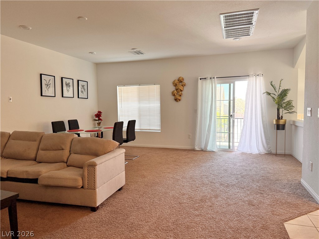 7777 South Westwind Road Las Vegas, NV 89139 - Photo 36 of 46 An inviting open-concept living space features a dining area and balcony access.