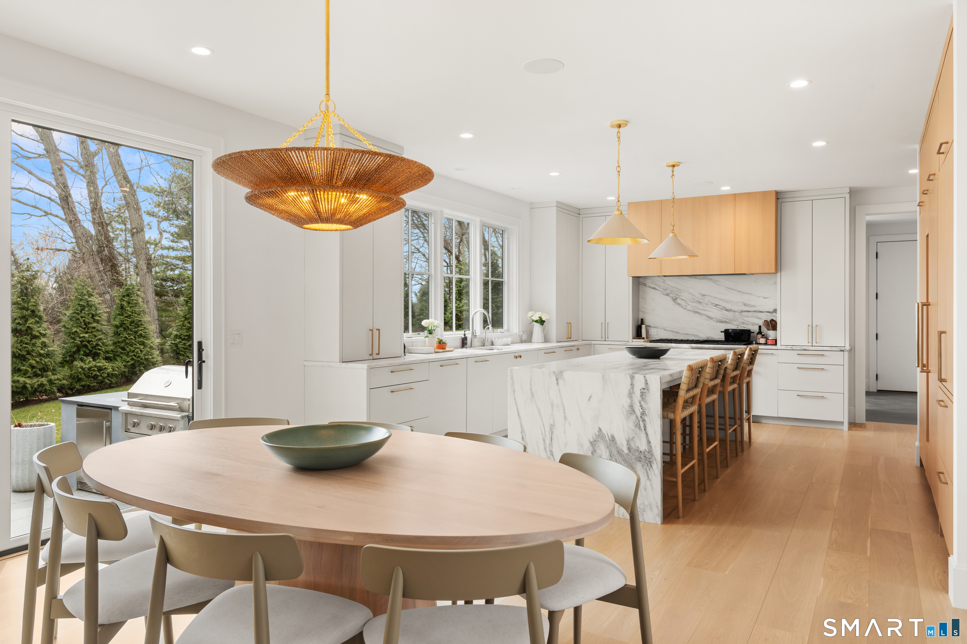 19 Mortar Rock Road Westport, CT 06880 - Photo 18 of 39 a kitchen with kitchen island a dining table and chairs