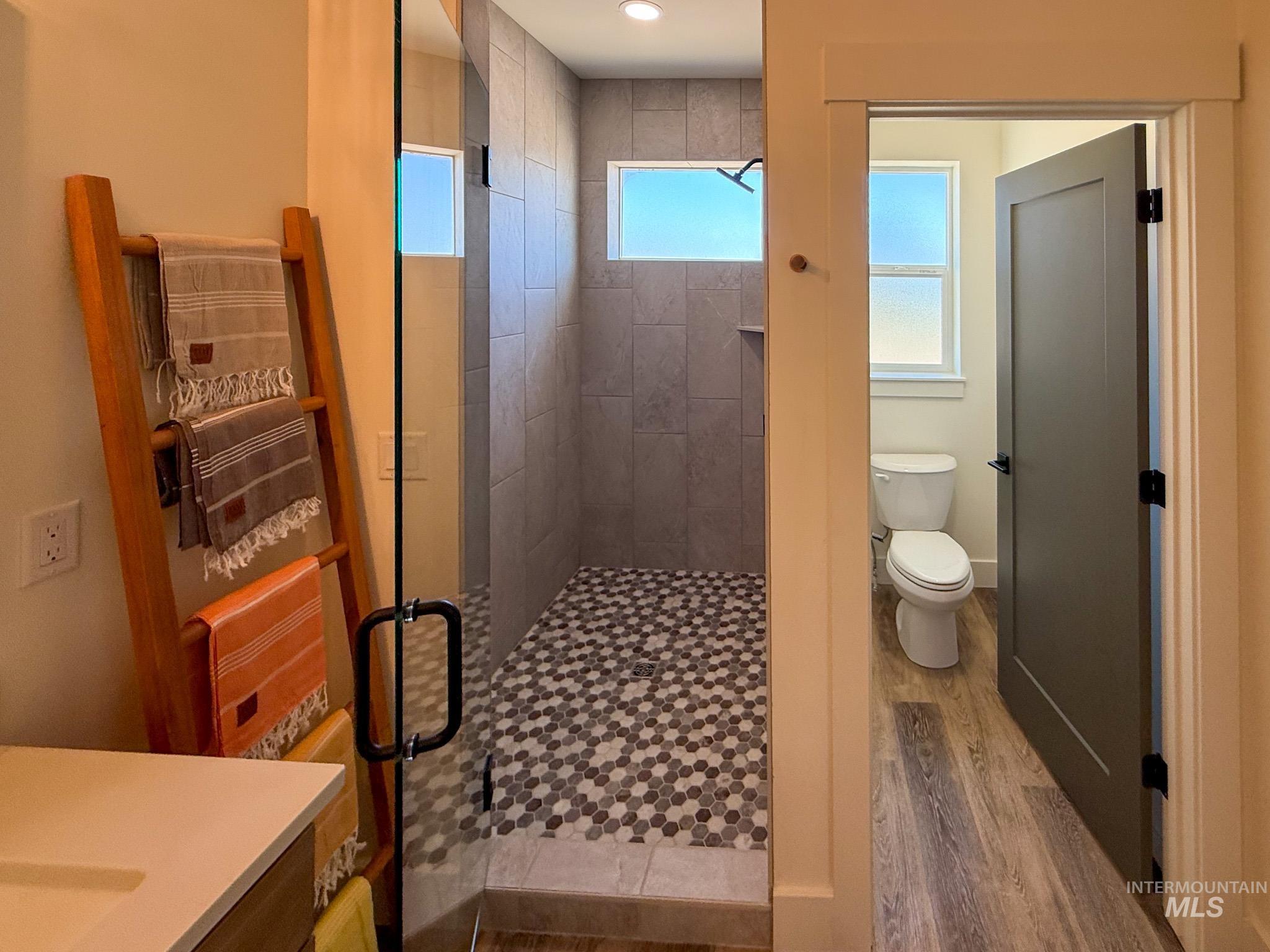 1108 Sage Rupert, ID 83350 - Photo 12 of 21 Glass-enclosed shower with a hex tile floor and large format wall tiles