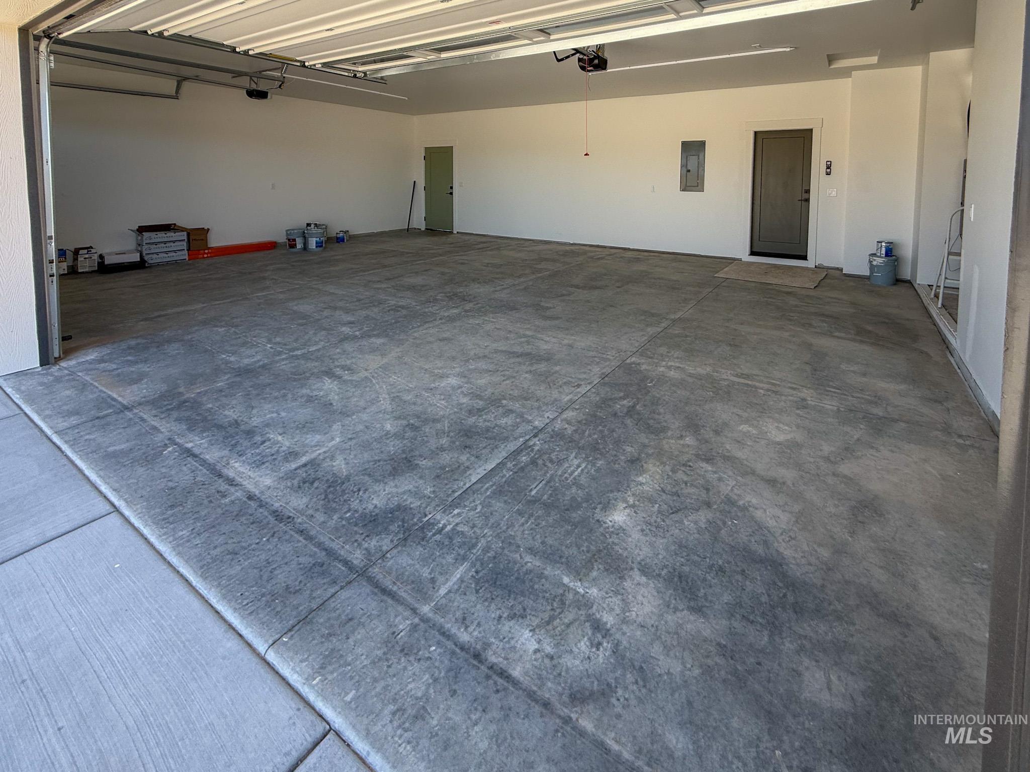 1108 Sage Rupert, ID 83350 - Photo 20 of 21 Spacious garage featuring a durable concrete floor, an overhead door with opener, and direct access doors