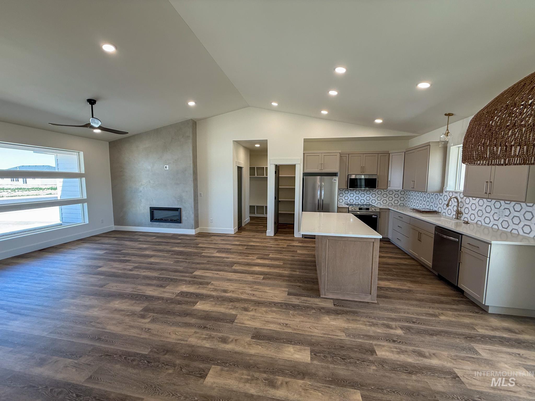 1108 Sage Rupert, ID 83350 - Photo 2 of 21 Open-concept living space featuring wood-finish flooring, a vaulted ceiling, and recessed lighting