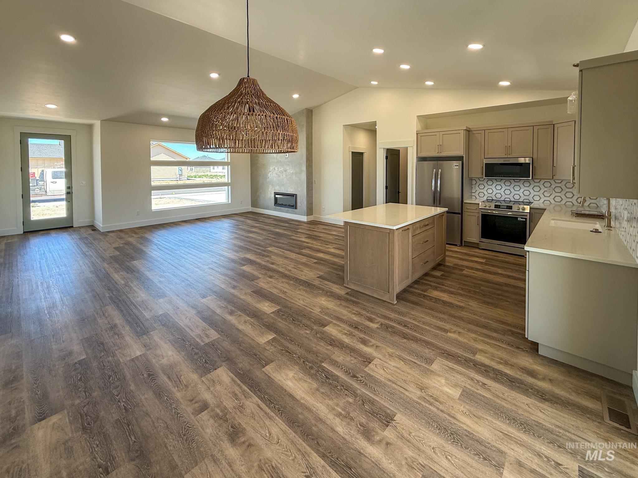 1108 Sage Rupert, ID 83350 - Photo 6 of 21 Open concept living area featuring wood-finish flooring, vaulted ceilings, and recessed lighting