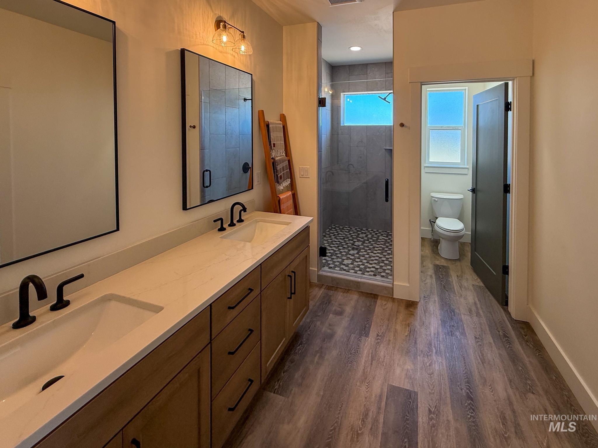 1108 Sage Rupert, ID 83350 - Photo 10 of 21 Dual vanity with undermount sinks and matte black fixtures, set on a light-toned countertop
