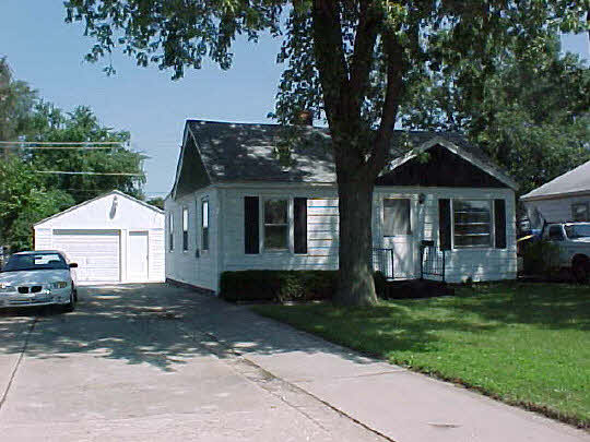 910 Windsor Road Loves Park, IL 61111 - Photo 1 of 6 a front view of a house with a garden