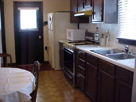 910 Windsor Road Loves Park, IL 61111 - Photo 3 of 6 a kitchen with stainless steel appliances granite countertop a sink stove and refrigerator