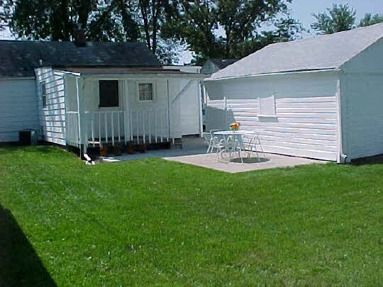 910 Windsor Road Loves Park, IL 61111 - Photo 5 of 6 a view of a backyard with plants and a garden