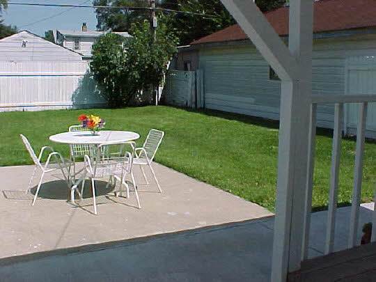 910 Windsor Road Loves Park, IL 61111 - Photo 6 of 6 a patio with a table and chairs and potted plants