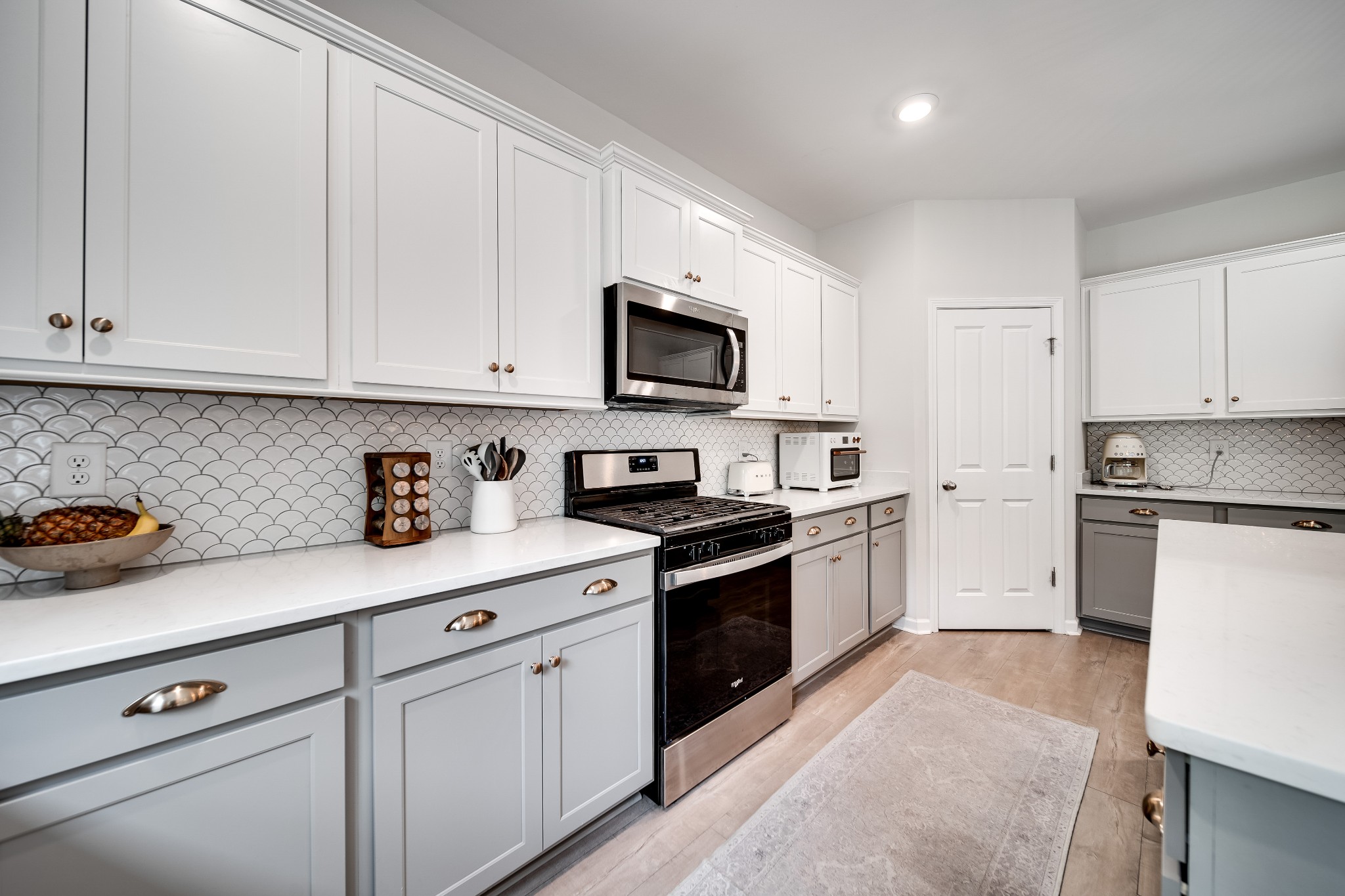 7301 Audubon Cove Fairview, TN 37062 - Photo 24 of 67 a kitchen with granite countertop white cabinets and white stainless steel appliances