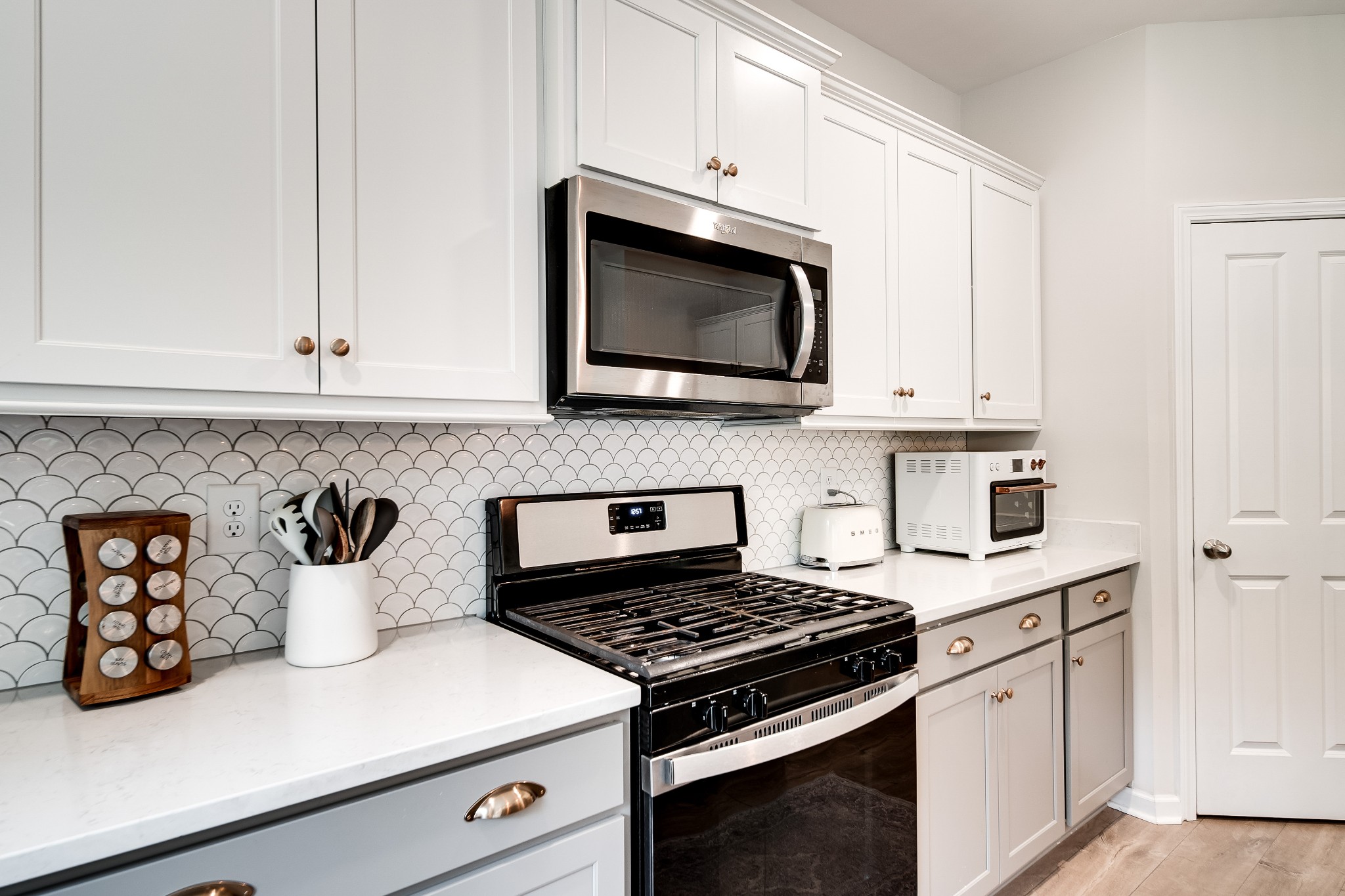 7301 Audubon Cove Fairview, TN 37062 - Photo 25 of 67 a kitchen with microwave cabinets and a stove top oven