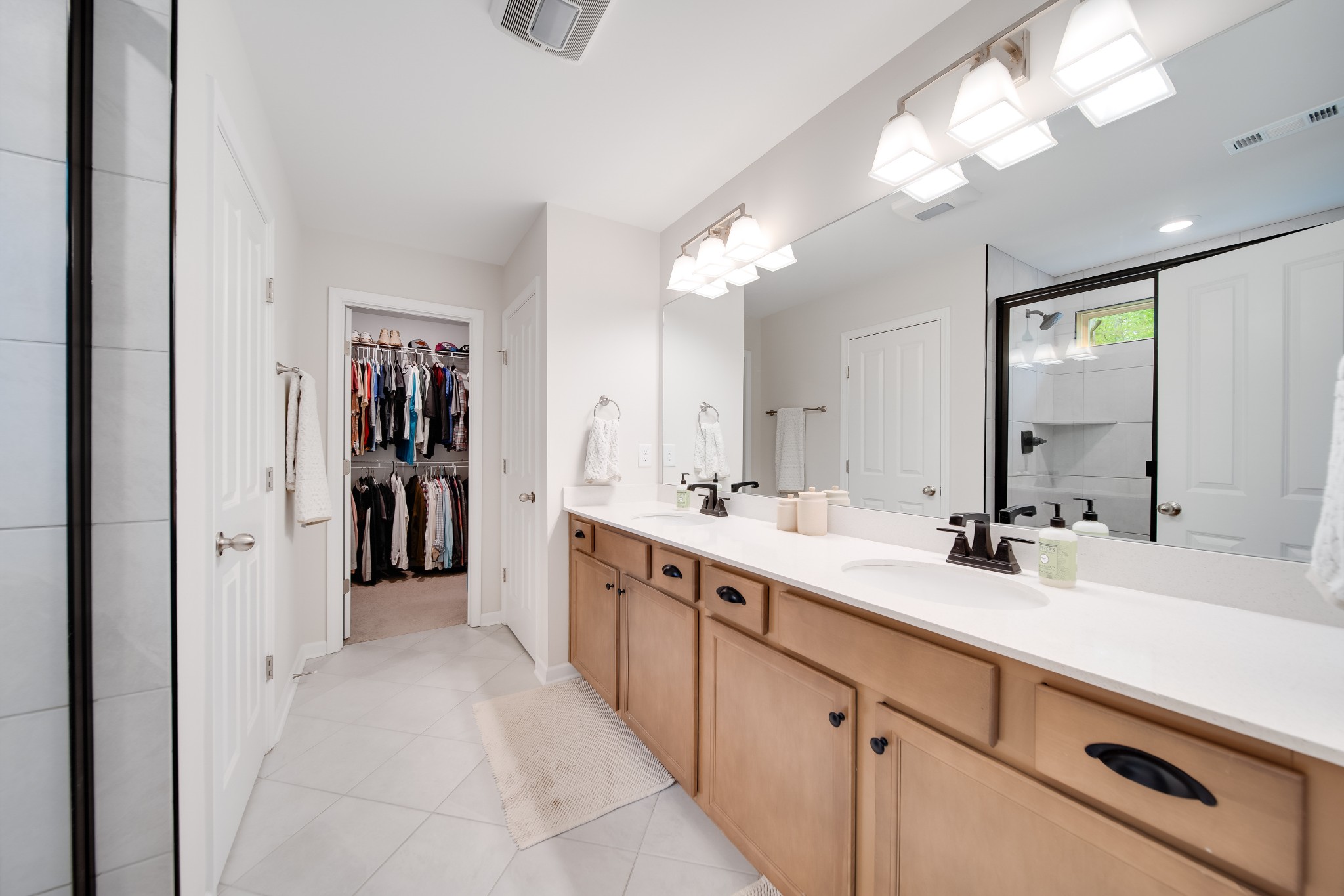 7301 Audubon Cove Fairview, TN 37062 - Photo 59 of 67 a spacious bathroom with a double vanity sink and a mirror