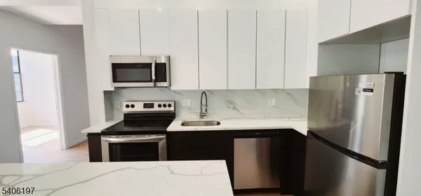 a kitchen with a refrigerator stove and microwave