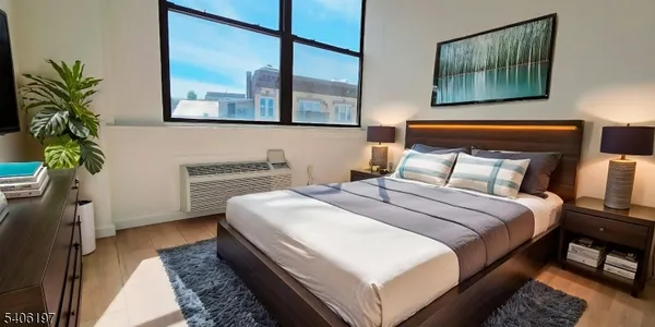 a bedroom with bed and a potted plant