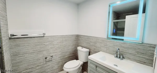 a bathroom with a sink a toilet and mirror