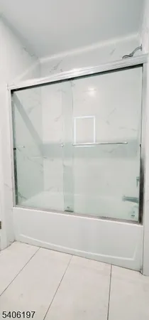 a bathroom with a shower and a bath tub