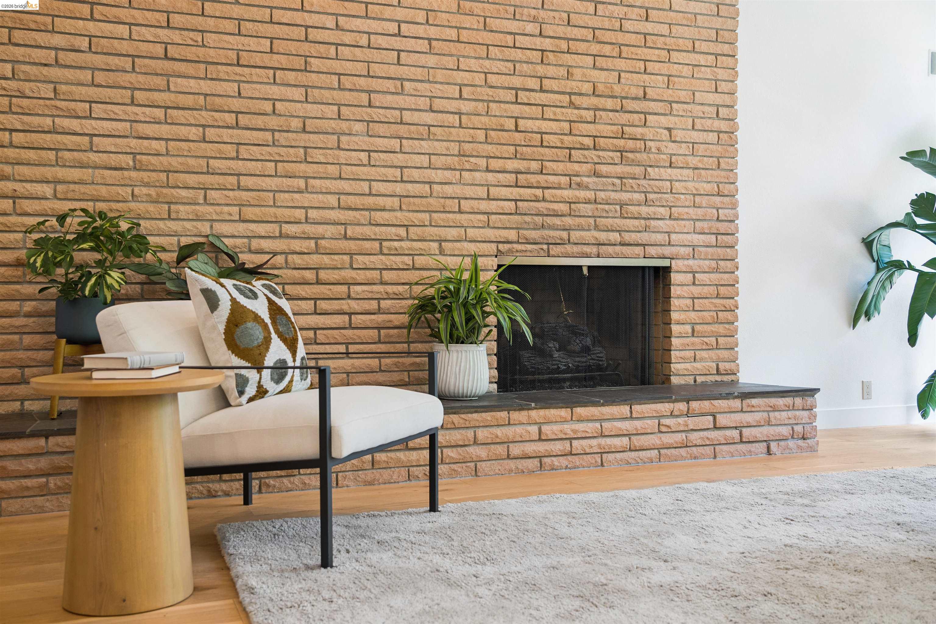 7 Jo Lin Court El Sobrante, CA 94803 - Photo 30 of 99 Brick fireplace with a black metal screen and a stone hearth
