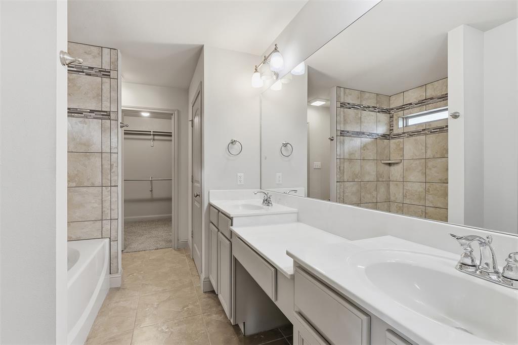2512 Guinn Farms Road Tyler, TX 75707 - Photo 24 of 29 a spacious bathroom with a shower sink and mirror