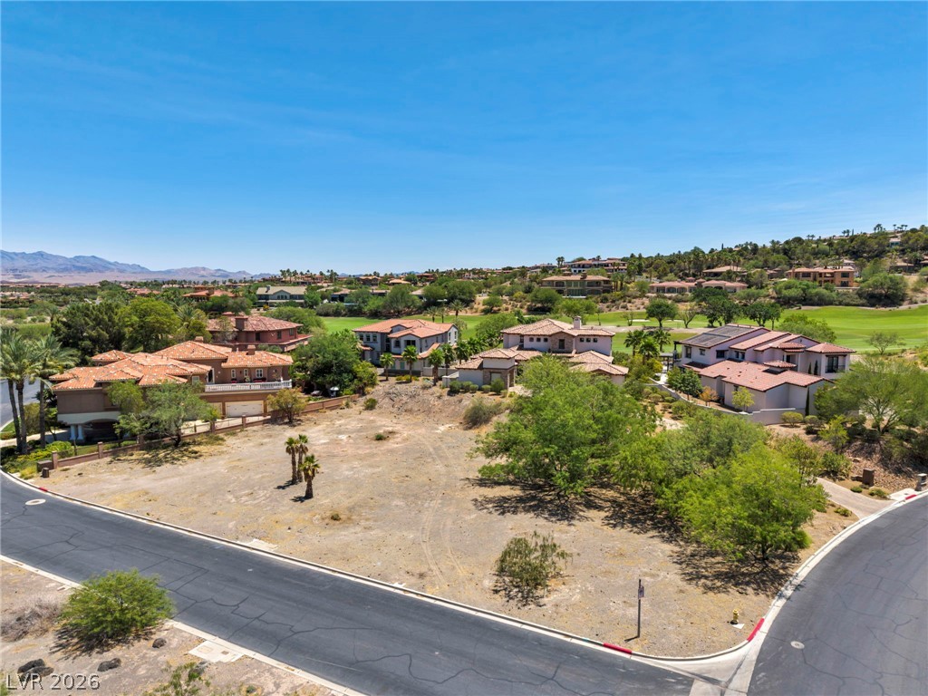 3 Rue Promenade Way Henderson, NV 89011 - Photo 4 of 26 An aerial perspective reveals a prime corner lot nestled amidst luxury homes and verdant golf course fairways.