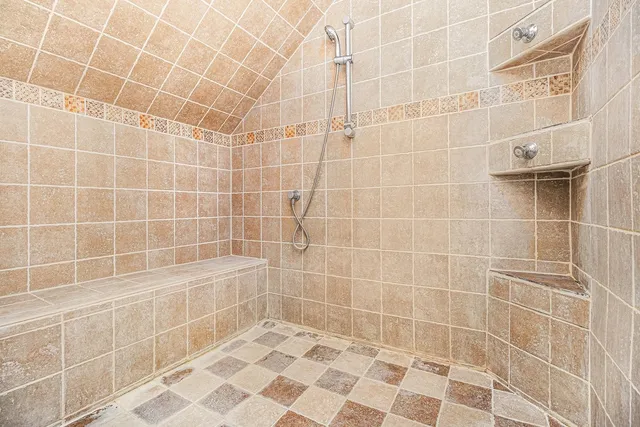 a bathroom with a tub a sink and a window