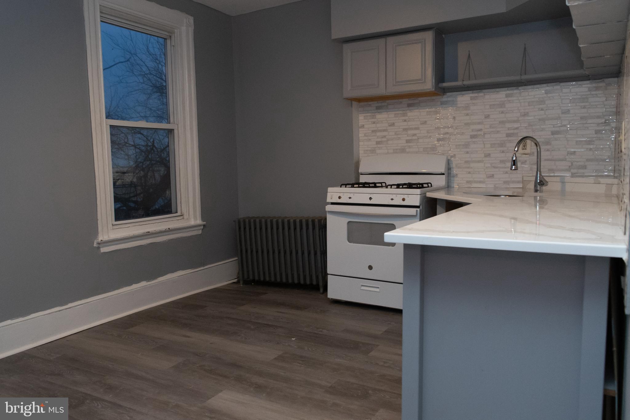 5841 North 12th Street Philadelphia, PA 19141 - Photo 2 of 2 a kitchen with a stove and a sink
