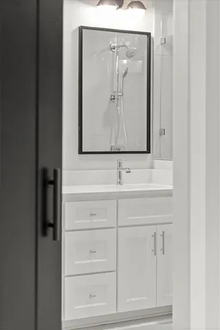 a view of an empty room with wooden floor and windows